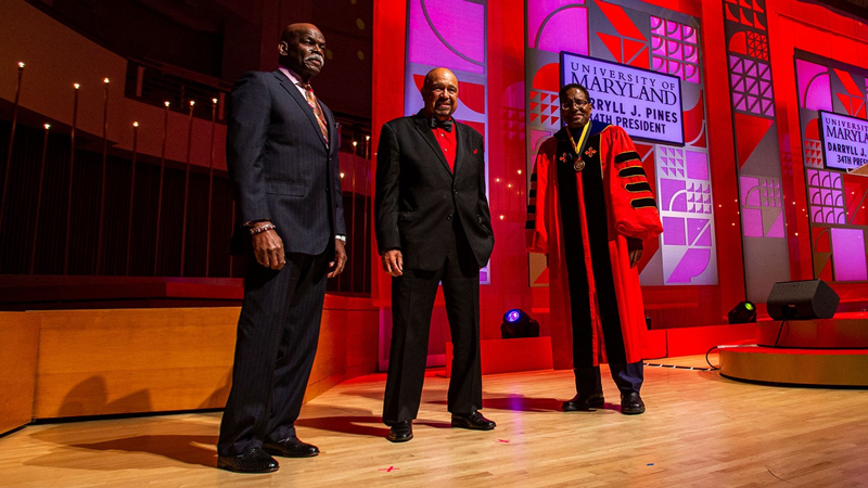 Left to Right: Billy Jones, Darryl Hill, and President Darryll Pines stand on-stage at President Pines' inauguration